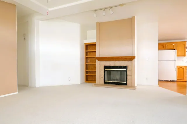 a view of an empty room with a fireplace