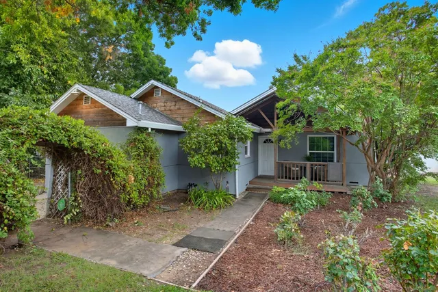 a front view of a house with garden