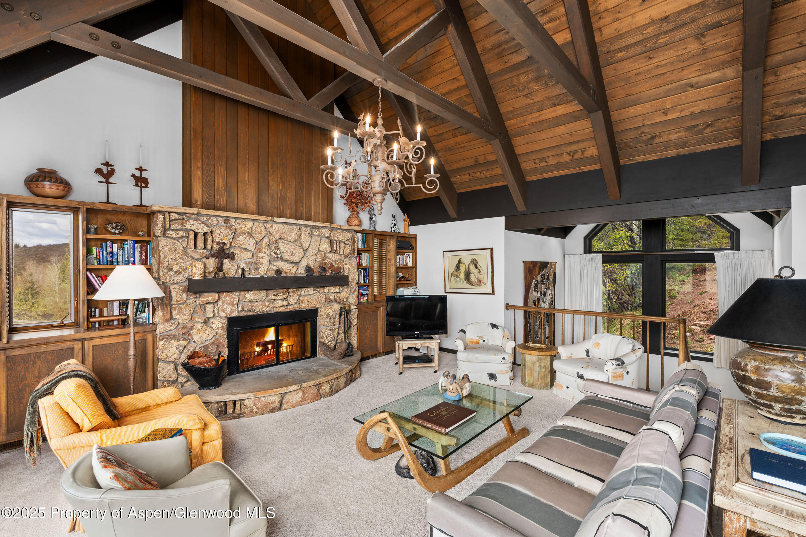 162 Bennett Bench Road Aspen, CO 81612 - Photo 11 of 46 a living room with furniture a fireplace and a dining table
