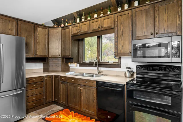 a kitchen table with chairs and window