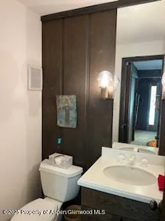 a view of a hallway with wooden floor and windows