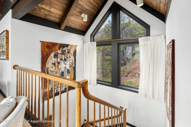 a spacious bedroom with a bed and a large window