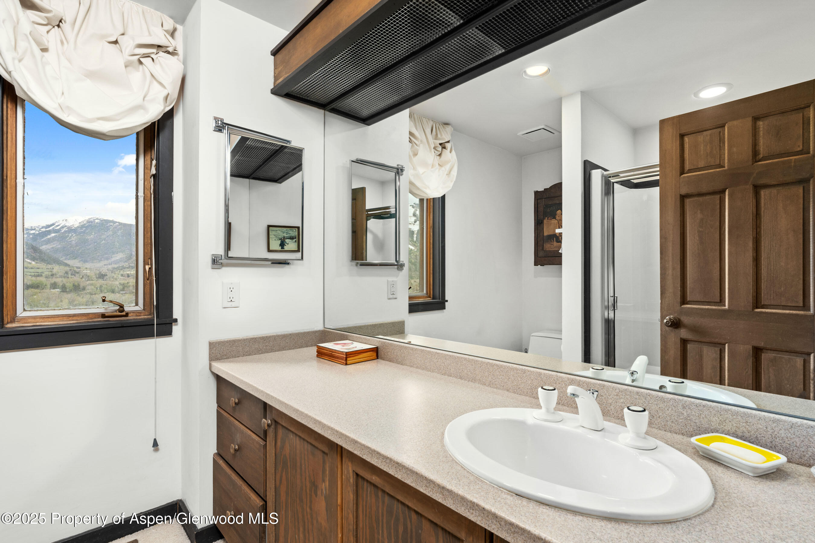 162 Bennett Bench Road Aspen, CO 81612 - Photo 23 of 46 a bathroom with a granite countertop sink and a mirror