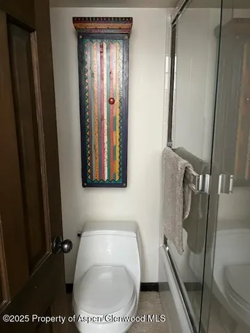 a bedroom with a bed and a dresser next to a window