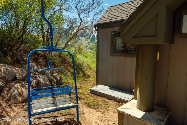 a view of a house with a street lush green forest