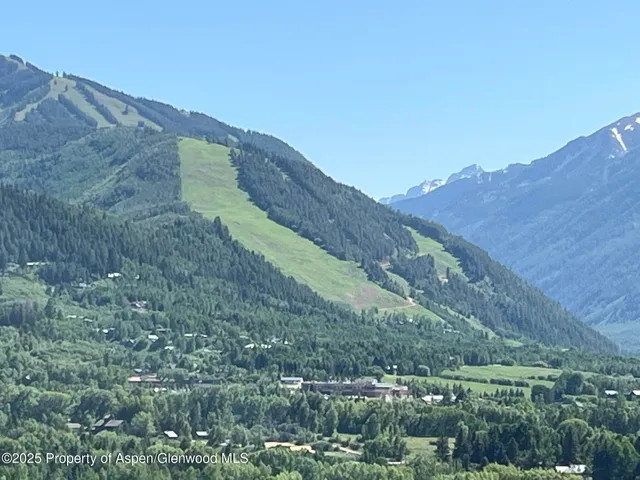 a view of a house with a mountain in the background