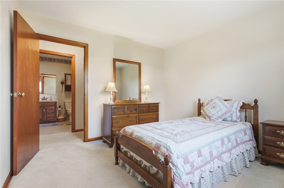 6718 Old Columbus Road South Vienna, OH 45369 - Photo 27 of 33 Bright bedroom with plush carpeting, offering serene comfort and direct bathroom access.