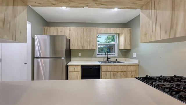 a kitchen with a refrigerator and a sink