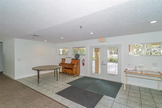 a living room with furniture a flat screen tv and a large window