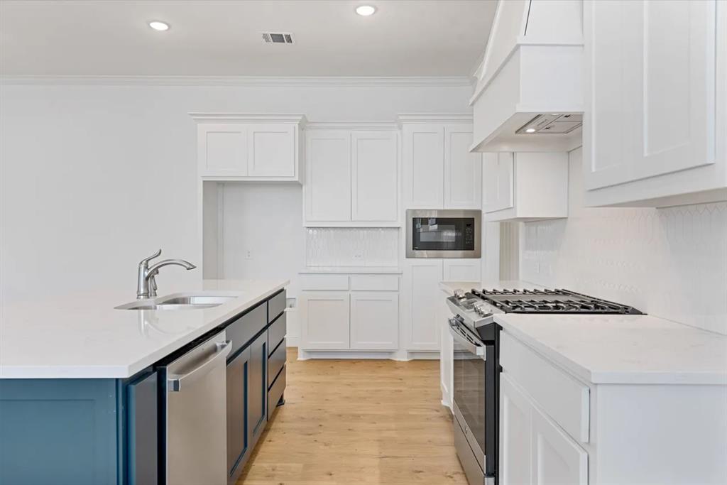 9337 Loggerhead Way Fort Worth, TX 76118 - Photo 20 of 40 a kitchen with stainless steel appliances granite countertop a sink stove and cabinets