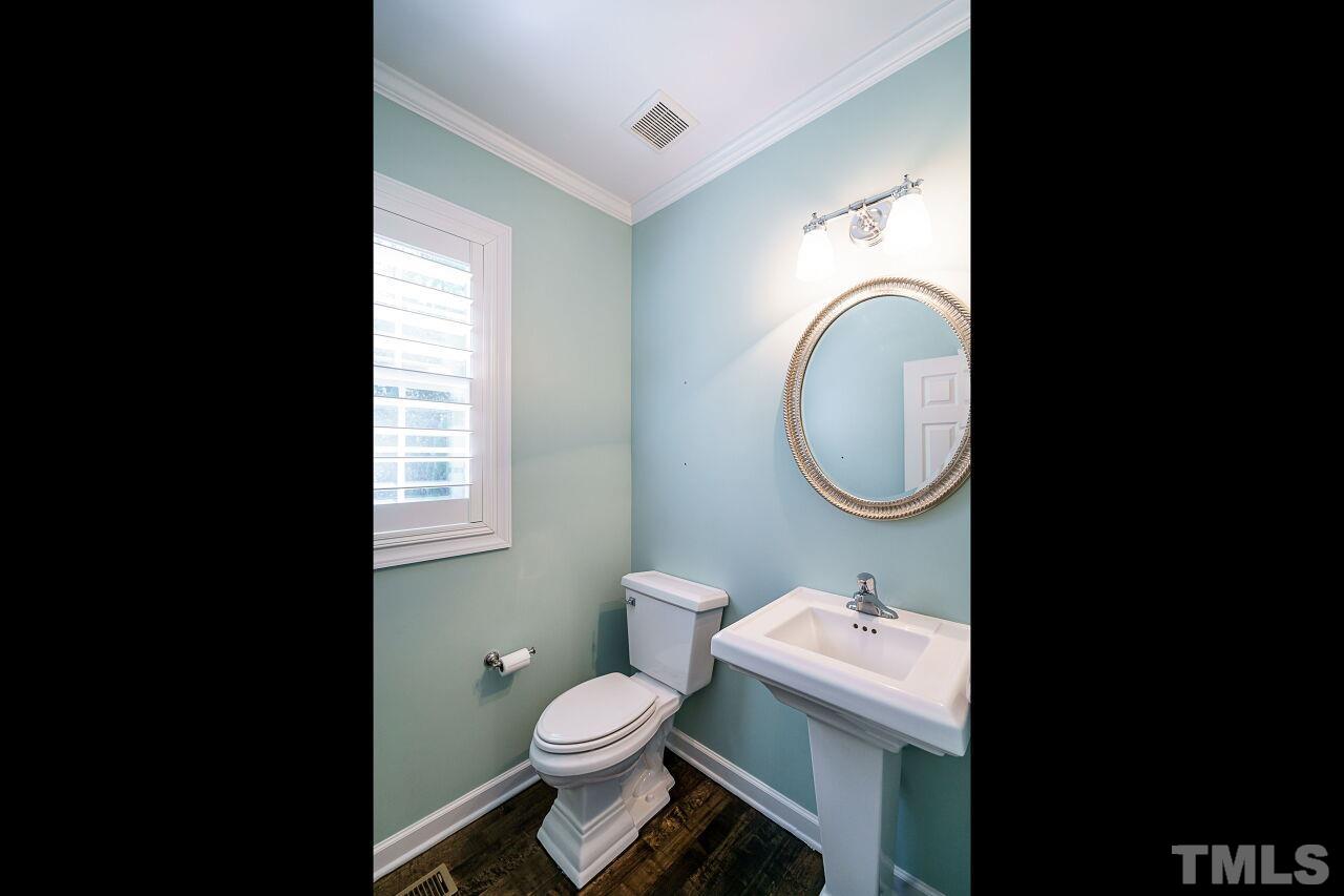 3003 Red Grape Drive Raleigh, NC 27607 - Photo 23 of 35 a bathroom with a toilet a sink and a mirror
