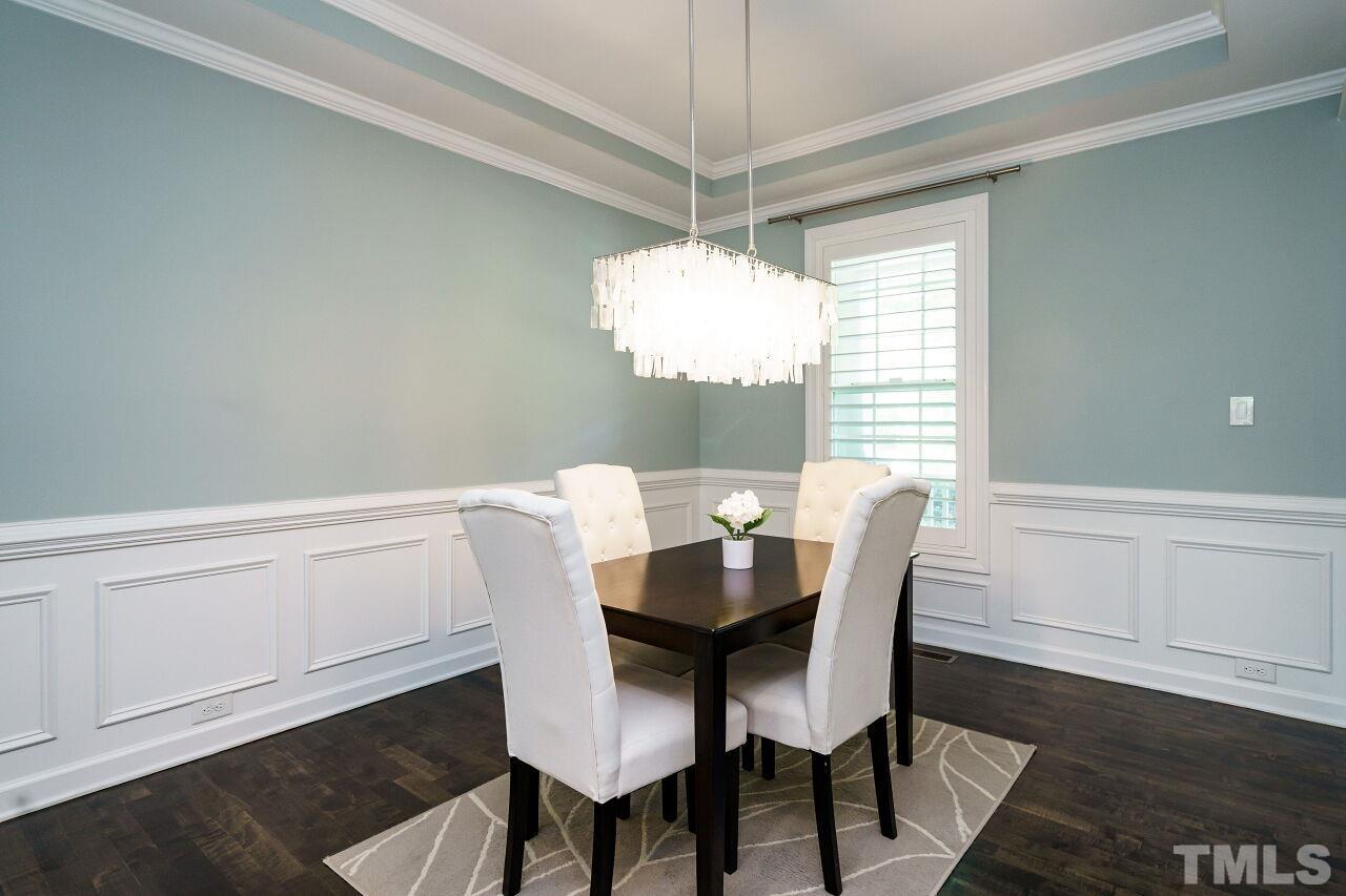 3003 Red Grape Drive Raleigh, NC 27607 - Photo 6 of 35 a dining room with furniture a chandelier and wooden floor