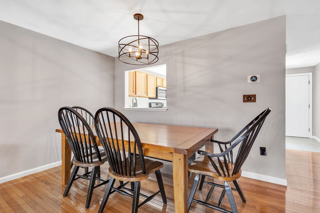 7 Deer Path, Unit 2 Maynard, MA 01754 - Photo 13 of 42 a view of a dining room with furniture window and wooden floor
