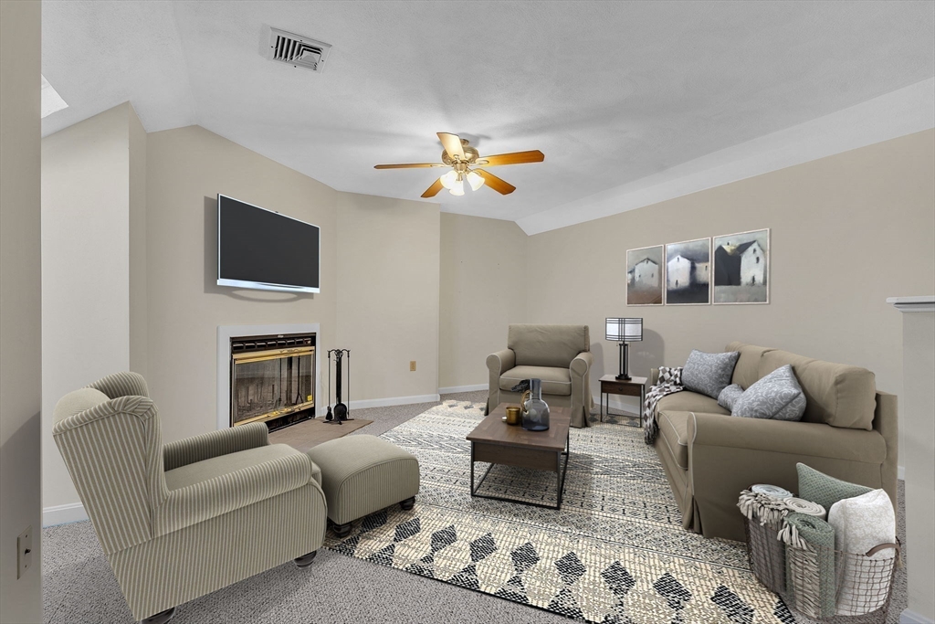 7 Deer Path, Unit 2 Maynard, MA 01754 - Photo 25 of 42 a living room with furniture a fireplace and a flat screen tv