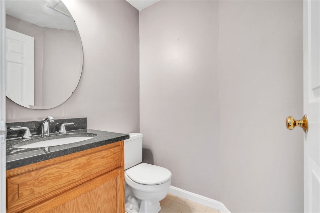 7 Deer Path, Unit 2 Maynard, MA 01754 - Photo 9 of 42 a bathroom with a sink and a mirror
