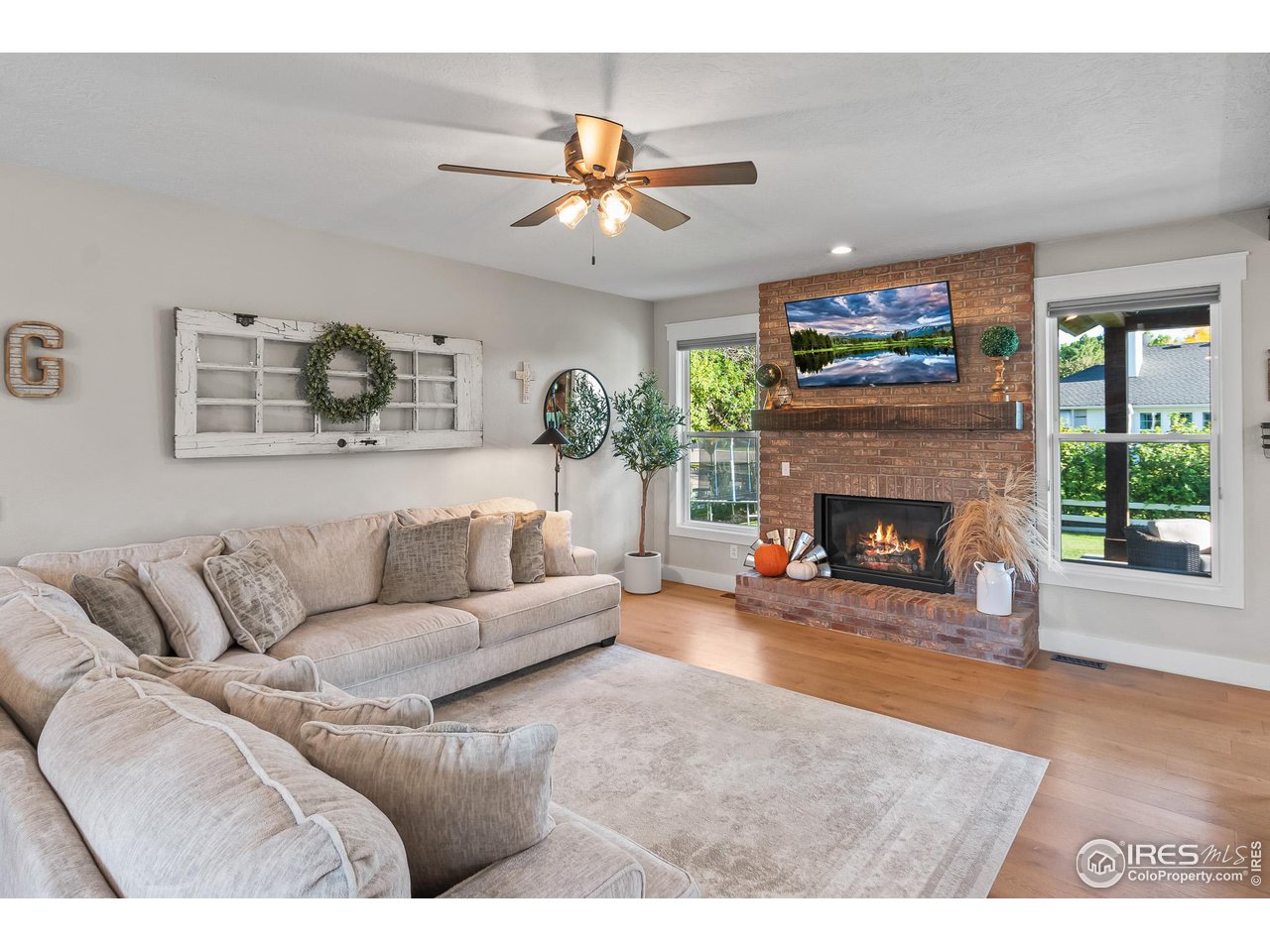 301 Pelican Cove Windsor, CO 80550 - Photo 11 of 38 a living room with furniture and a fireplace
