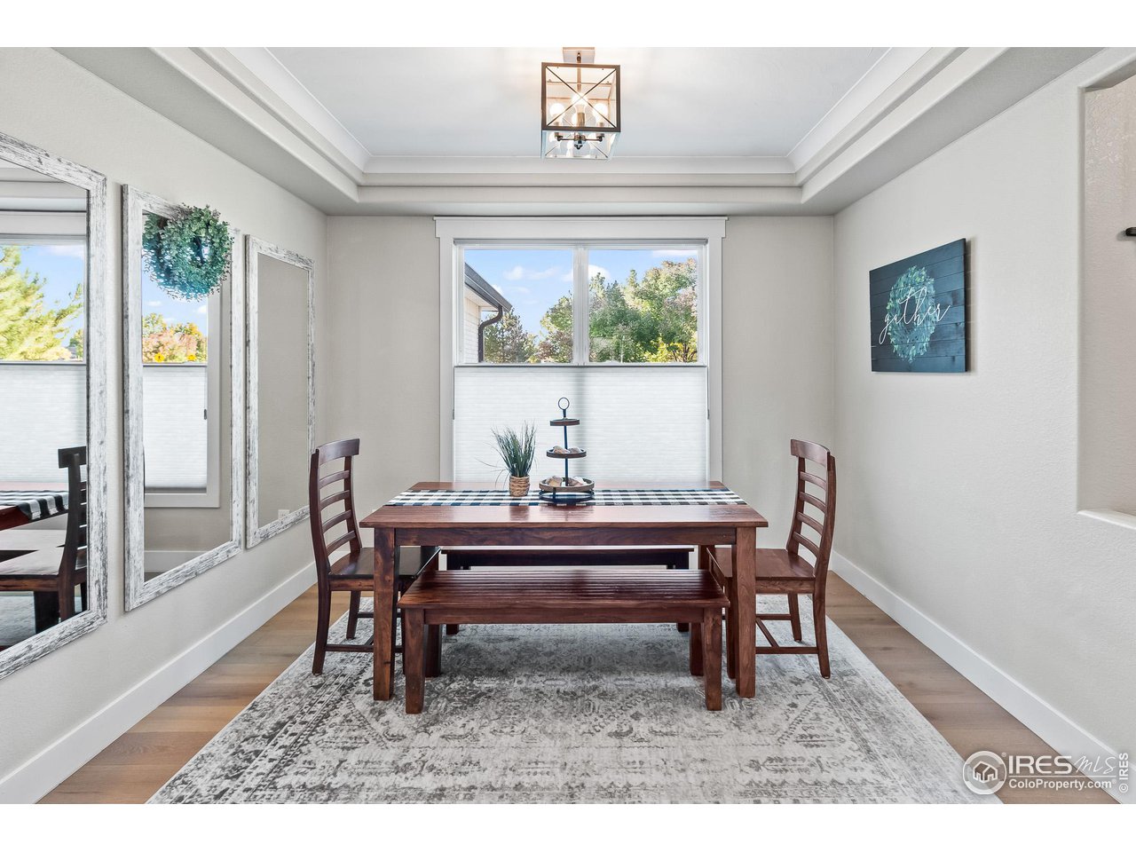 301 Pelican Cove Windsor, CO 80550 - Photo 12 of 38 a view of a dining room with furniture window and wooden floor