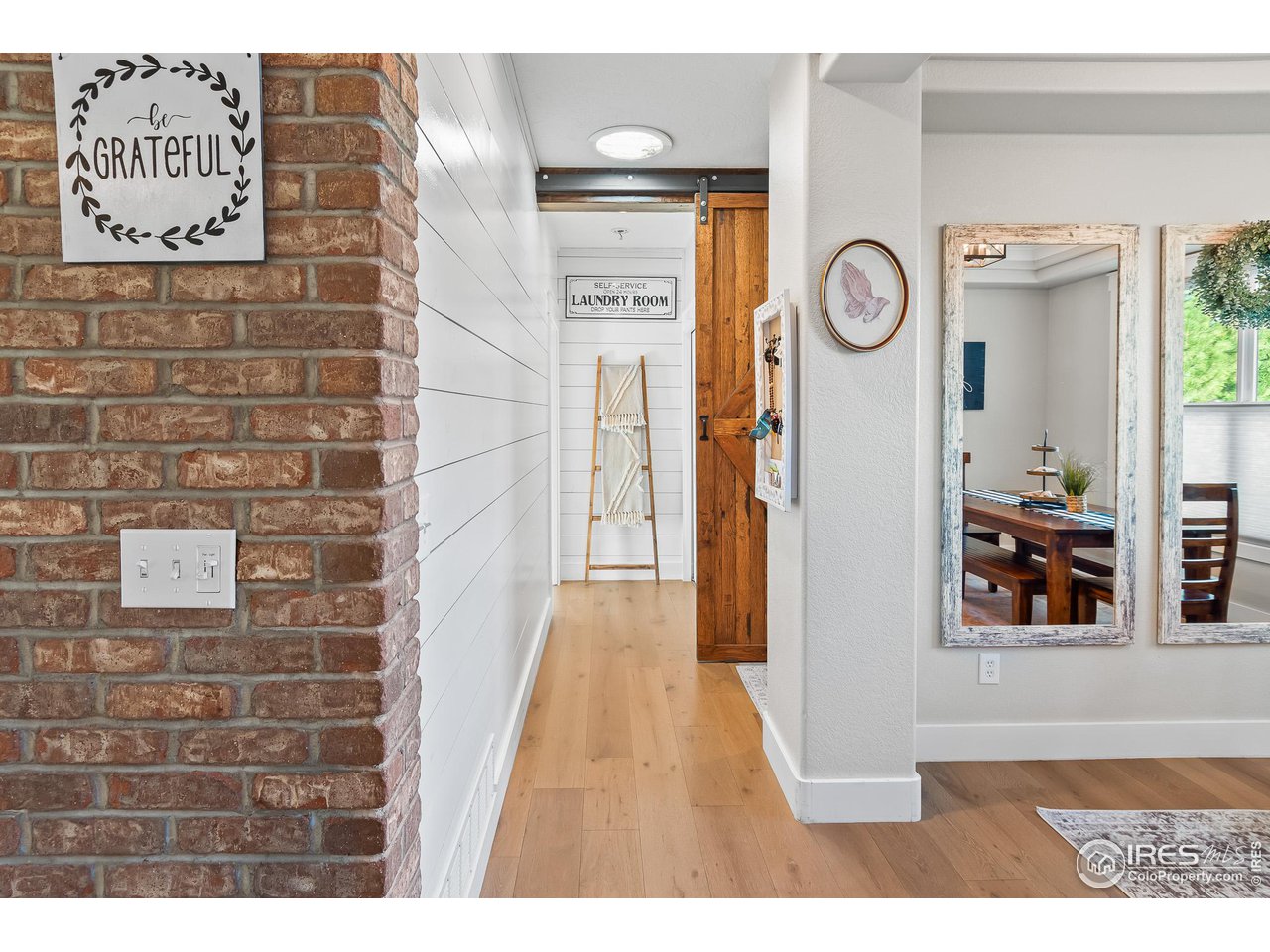 301 Pelican Cove Windsor, CO 80550 - Photo 18 of 38 a view of a hallway with wooden floor