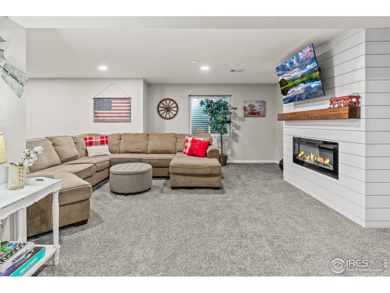301 Pelican Cove Windsor, CO 80550 - Photo 19 of 38 a living room with furniture and a fireplace