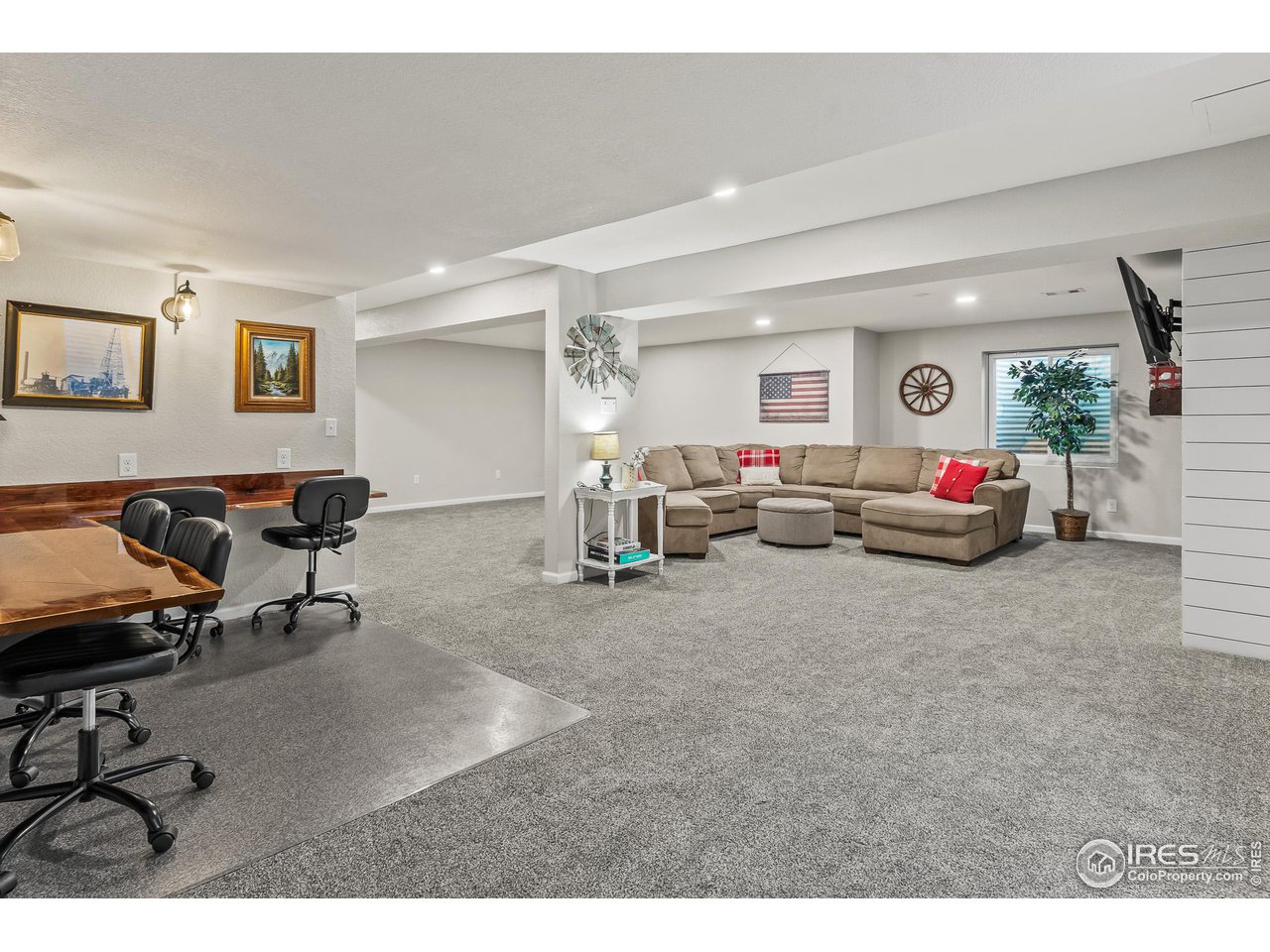 301 Pelican Cove Windsor, CO 80550 - Photo 20 of 38 a living room with furniture and a flat screen tv