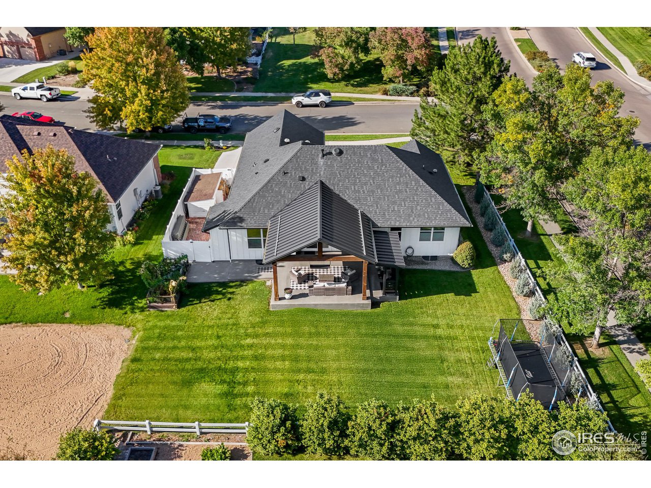 301 Pelican Cove Windsor, CO 80550 - Photo 30 of 38 a aerial view of a house with swimming pool garden view and trees