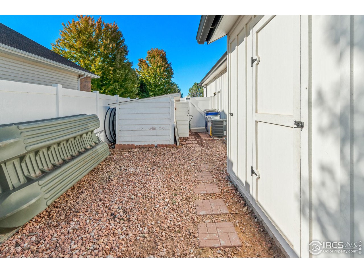 301 Pelican Cove Windsor, CO 80550 - Photo 31 of 38 a view of a backyard with a small cabin