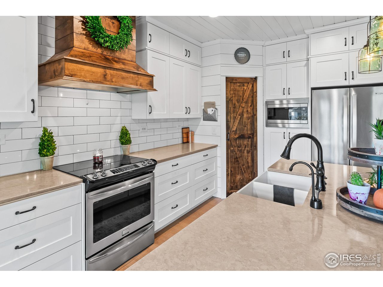 301 Pelican Cove Windsor, CO 80550 - Photo 8 of 38 a kitchen with stainless steel appliances a stove a refrigerator a sink a counter space and cabinets