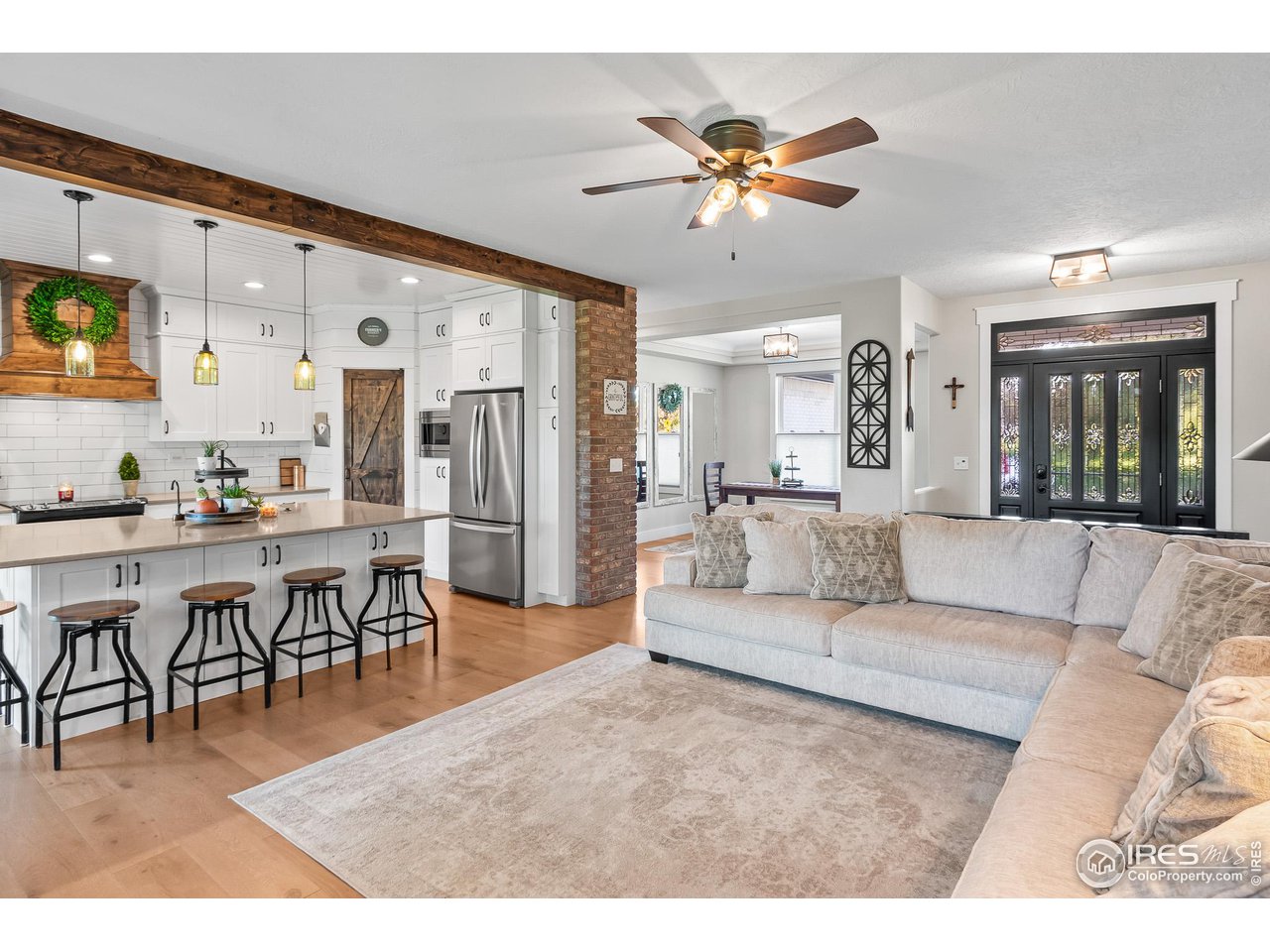 301 Pelican Cove Windsor, CO 80550 - Photo 10 of 38 a living room with furniture kitchen view and a chandelier