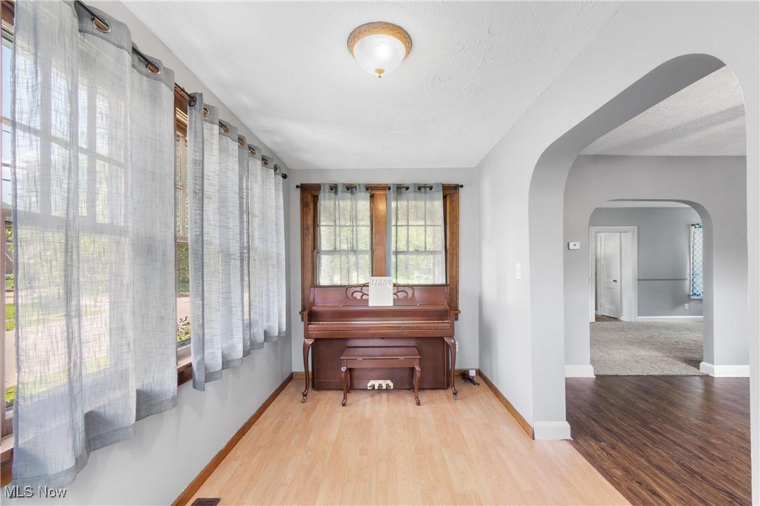 302 Poplar Avenue Northwest Canton, OH 44708 - Photo 11 of 34 Sitting room featuring arched walkways and wood finished floors