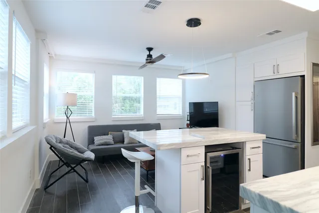 a kitchen with a table chairs and refrigerator