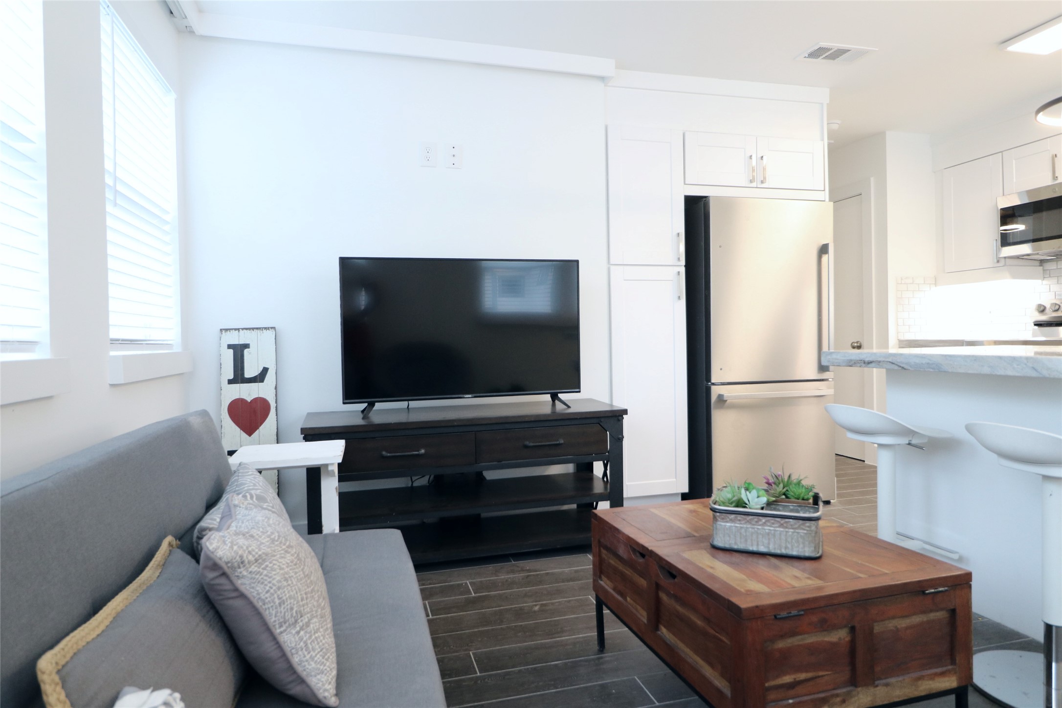 412 Pacific Street, Unit 2E Houston, TX 77006 - Photo 6 of 13 a living room with furniture and a flat screen tv