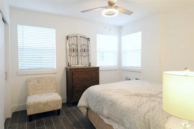 a bedroom with a bed and a chair