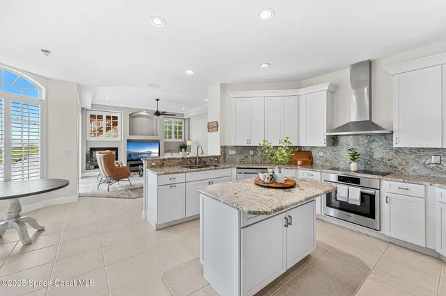 a kitchen with granite countertop a sink and cabinets