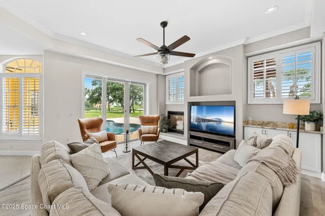a bedroom with a large bed chandelier and a window
