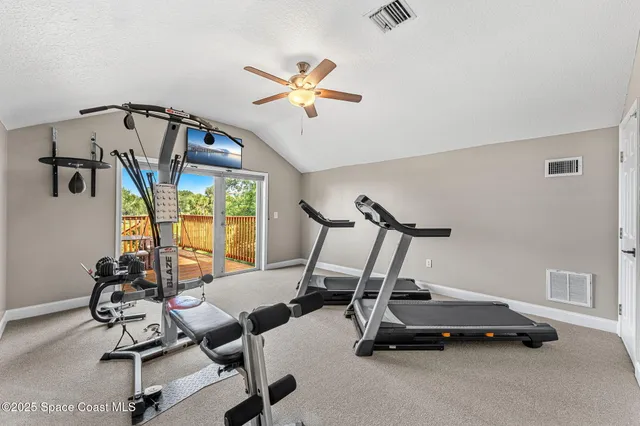 a view of a house with wooden deck and furniture