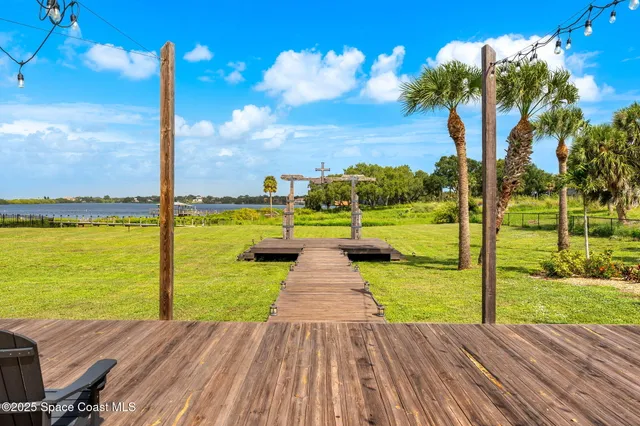 a view of a balcony with wooden floor and fence