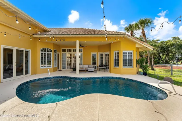 a backyard of a house with barbeque oven table and chairs