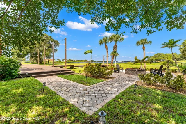 an aerial view of a house with a big yard