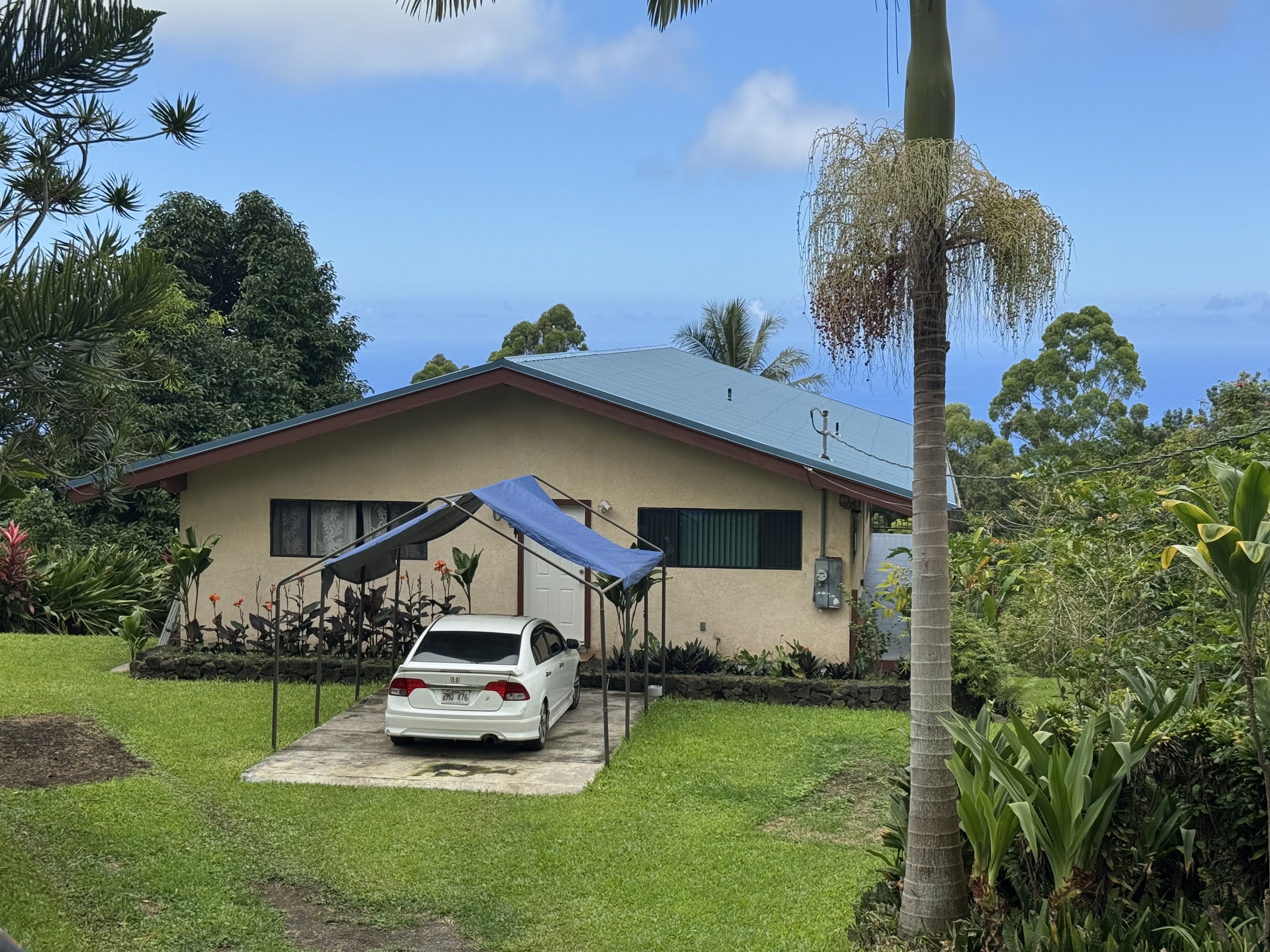 84-1164 Bruner Road Captain Cook, HI 96704 - Photo 11 of 13 a front view of a house with garden