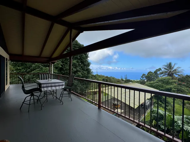 a view of balcony with chairs and wooden fence