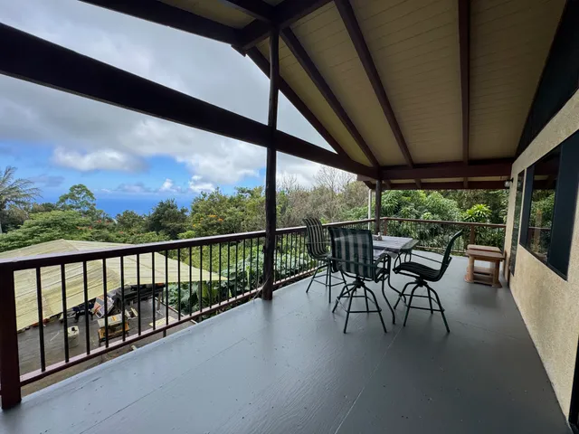 a view of a two chairs in the balcony