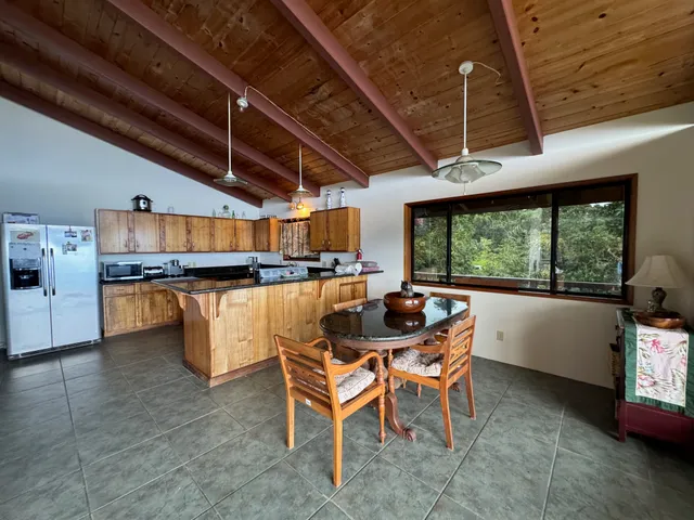 a dining room with furniture and a floor to ceiling window