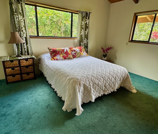 84-1164 Bruner Road Captain Cook, HI 96704 - Photo 10 of 13 a bed sitting in a bedroom next to a window