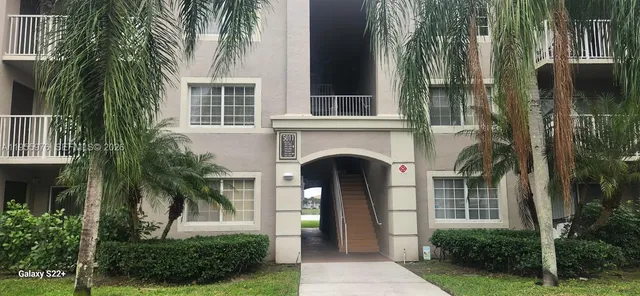 a front view of a house with plants and garden
