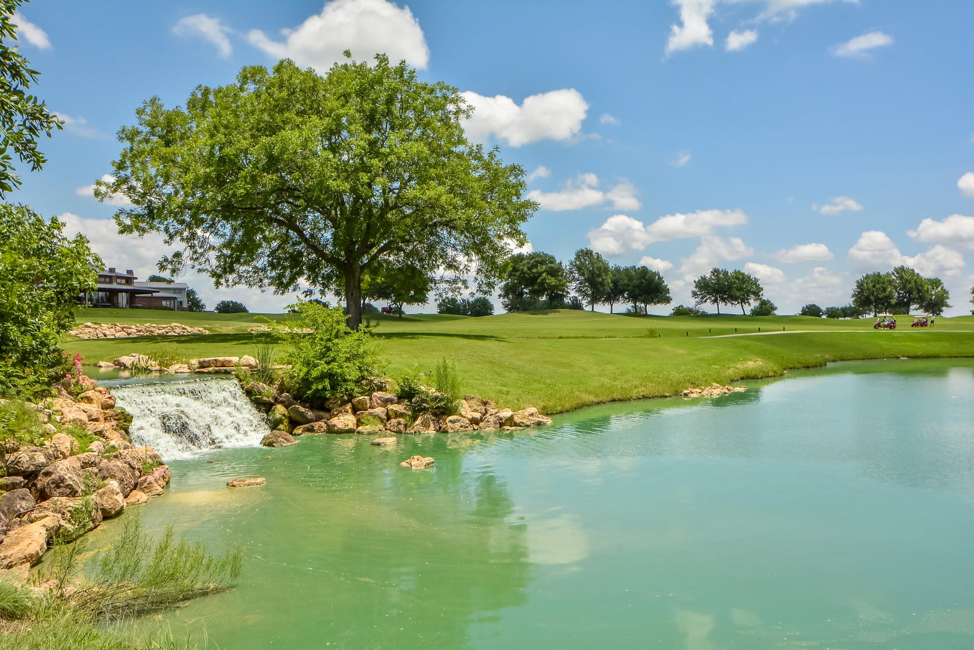2004 Autumn Run Lane Round Rock, TX 78665 - Photo 28 of 37 A tranquil golf course vista unfolds with a serene pond and a picturesque waterfall feature.