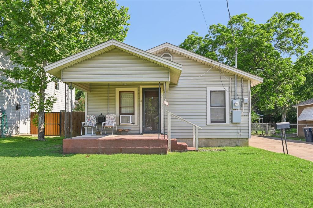 a front view of house with yard and green space