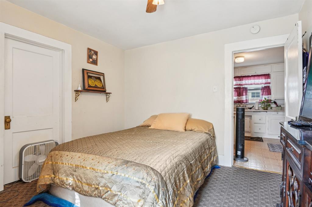 2509 Bird Street Fort Worth, TX 76111 - Photo 11 of 30 a bedroom with a bed and furniture