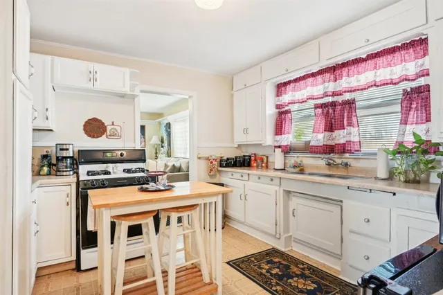 a kitchen with a stove a sink and a refrigerator