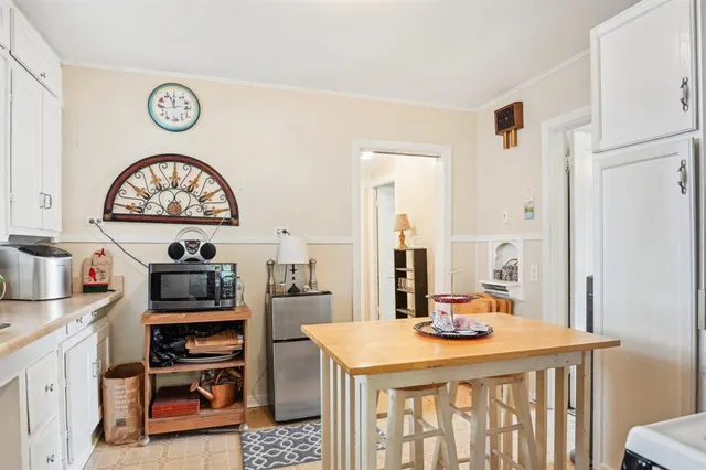a kitchen with a stove a refrigerator and a table