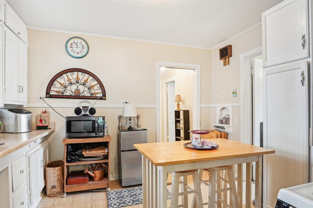 2509 Bird Street Fort Worth, TX 76111 - Photo 28 of 30 a kitchen with a stove a refrigerator and a table